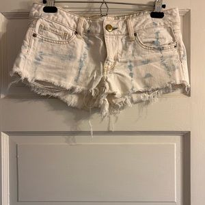 White denim shorts with faded blue denim